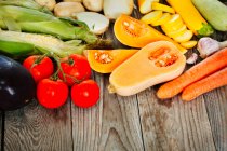 Fresh vegetables and fruits on wooden background — Stock Photo