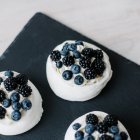 Blick auf Pavlova-Desserts mit Blaubeeren und Brombeeren auf Schiefer — Stockfoto
