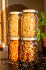 Jars of fresh  lentils, granola, nuts and seeds — Stock Photo