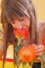 Portrait of a Woman smelling flowers — Stock Photo