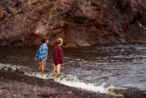 Two boys paddling in a river, United States — Stock Photo