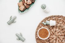 Cup of coffee with ceramic cacti and cookies — Stock Photo