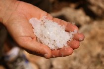 Male hand holding fresh sea salt outdoor — Stock Photo