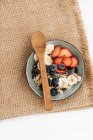 Overhead view of a bowl of granola with fresh fruit — Stock Photo