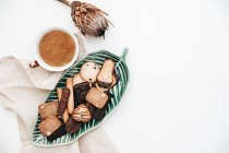 Cup of coffee with cookies and a protea flower — Stock Photo