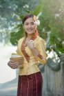 Woman wearing a traditional Laos costume carrying a bowl of rice, Laos — Stock Photo