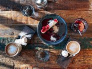 Overhead view of coffee, mulled wine and cheesecake with cherries — Stock Photo