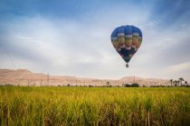 Гаряча повітряна куля летить над царською долиною, пишністю та самоцвітом. — стокове фото