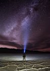 Man standing in Badwater Basin wearing a headlamp, Death Valley National Park, Inyo County, California, United States — Stock Photo