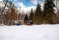 Three boys sledging, Wisconsin, United States — Stock Photo