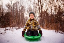 Boy sitting on a sledge, Wisconsin, United States — Stock Photo
