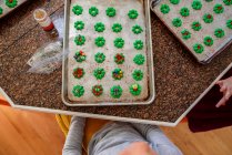 Two children standing in the kitchen decorating Cookies — Stock Photo