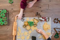 Children making Christmas cookies on table, top view — Stock Photo