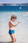 Boy standing in the sea dancing, Bulgaria — Stock Photo