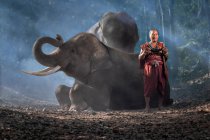 Portrait of The old man and elephants on blackground ,Vintage style. Surin Thailand. — Stock Photo