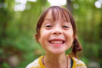 Portrait of a smiling girl standing outdoors, United States — Stock Photo