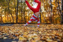 Little boy playing on trampoline in autumnal forest — Foto stock