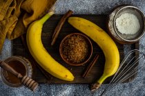 Overhead view of ingredients for honey cinnamon baked banana pie on a table — Stock Photo