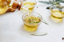 Fresh olive oil on white background — Stock Photo