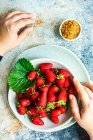 Healthy eating concept with raw fresh strawberries served in a bowl on a concrete background — Stock Photo
