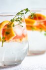 Summer cocktail with grapefruit and thyme as a summer background concept — Stock Photo