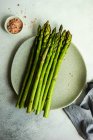Organic food concept with asparagus on stone table with copy space — Stock Photo