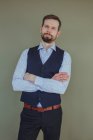 Portrait of a handsome man with a beard wearing a shirt and waistcoat — Stock Photo