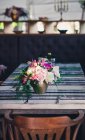 Bunch of flowers on dining room table — Stock Photo