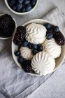 Overhead view of zefir dessert with blueberries and blackberries on a table — Stock Photo