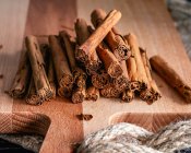 Cinnamon sticks and spices on wooden background — Stock Photo