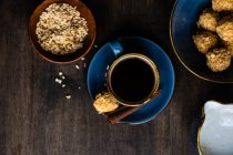 Cup of coffee and homemade snacks on table — Stock Photo