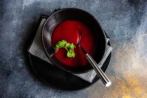 Portion of creamy beetroot soup served on table — Stock Photo