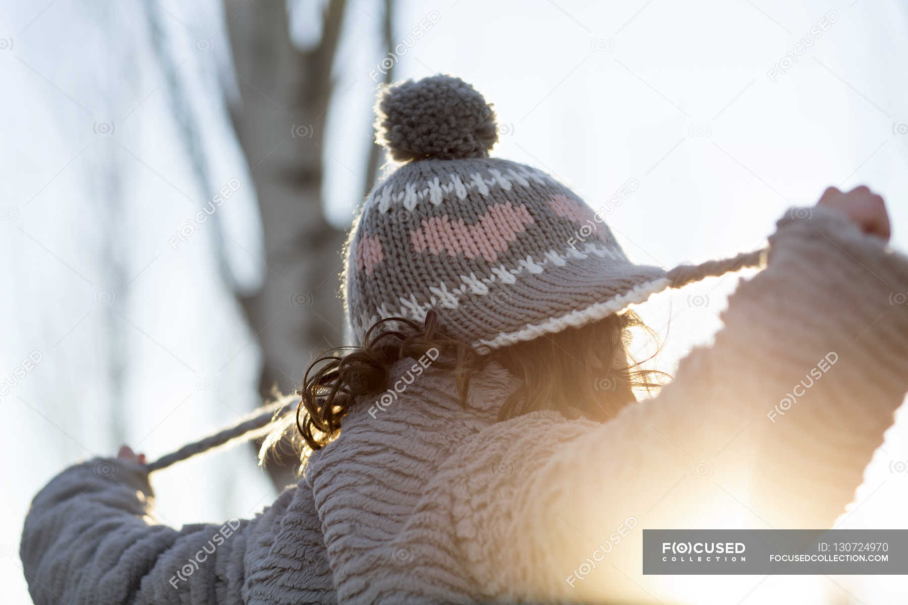 Girl pulling hat — enjoy, head and shoulders Stock Photo 130724970