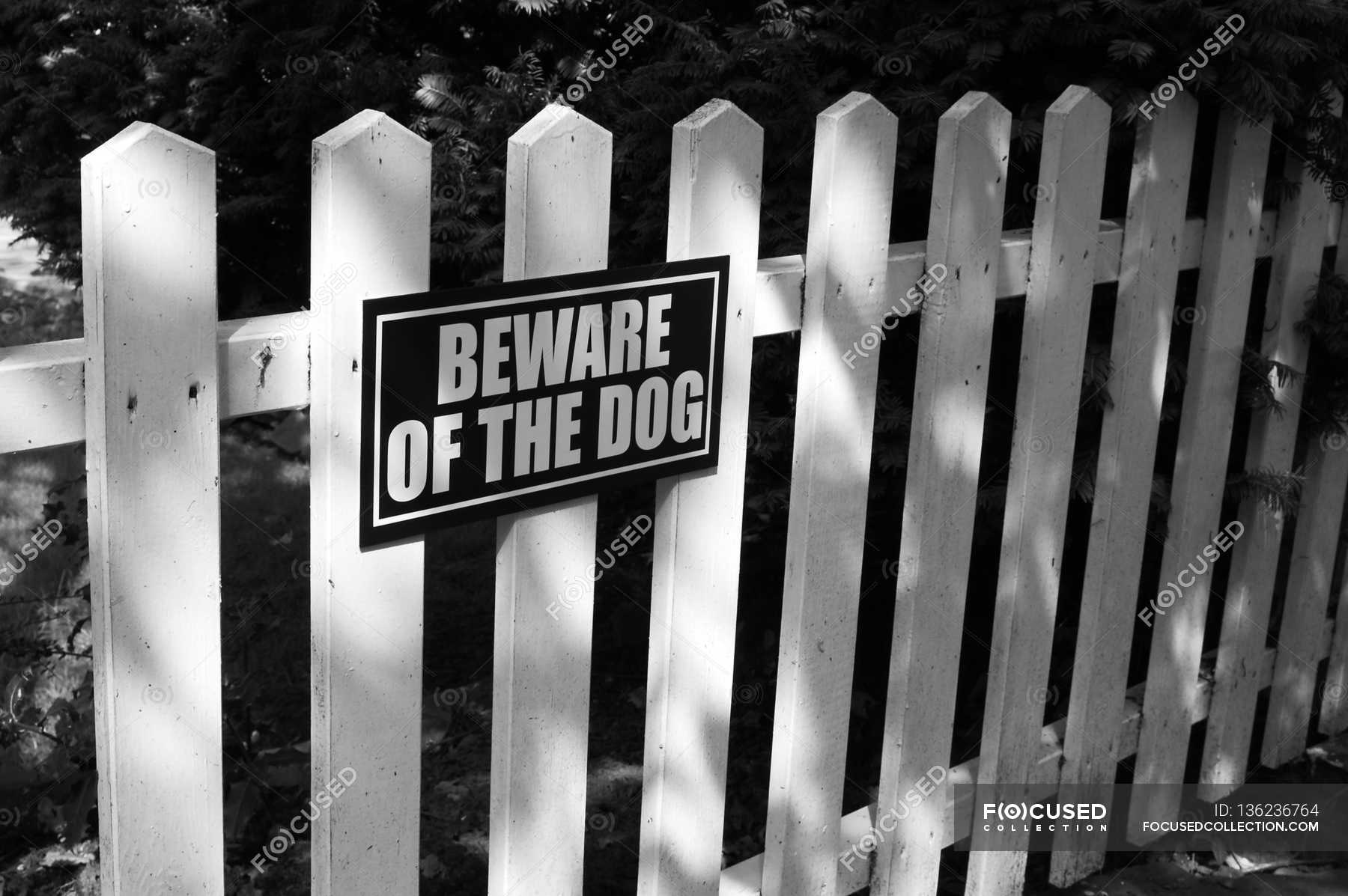 beware-of-dog-sign-focus-on-foreground-horizontal-stock-photo