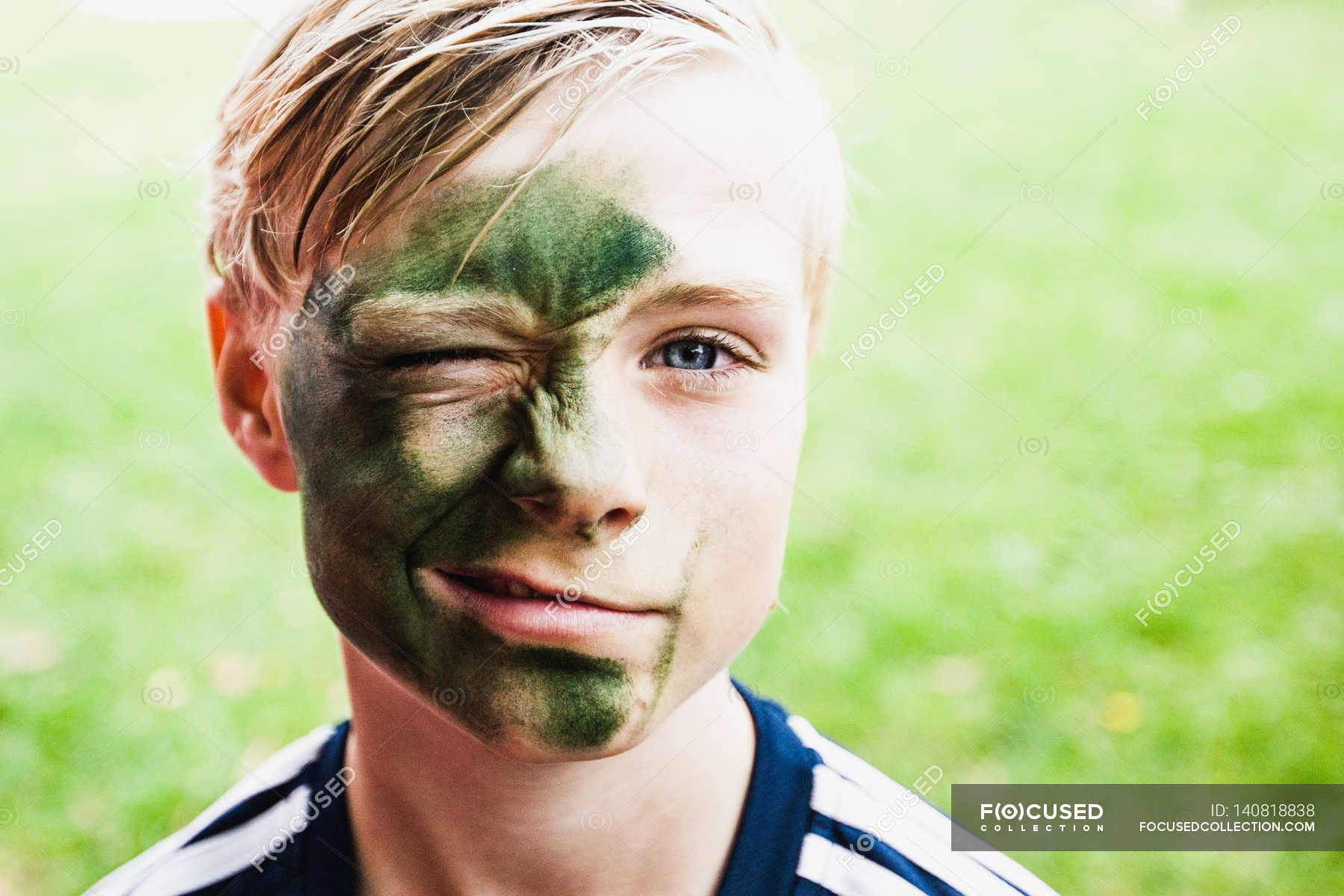 Young boy winking at camera — hair, face - Stock Photo | #140818838