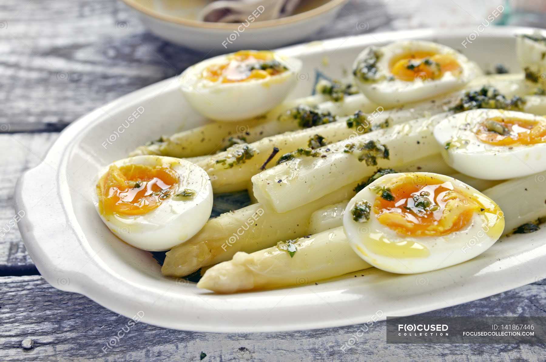 White asparagus and boiled eggs — horizontal, wooden Stock Photo