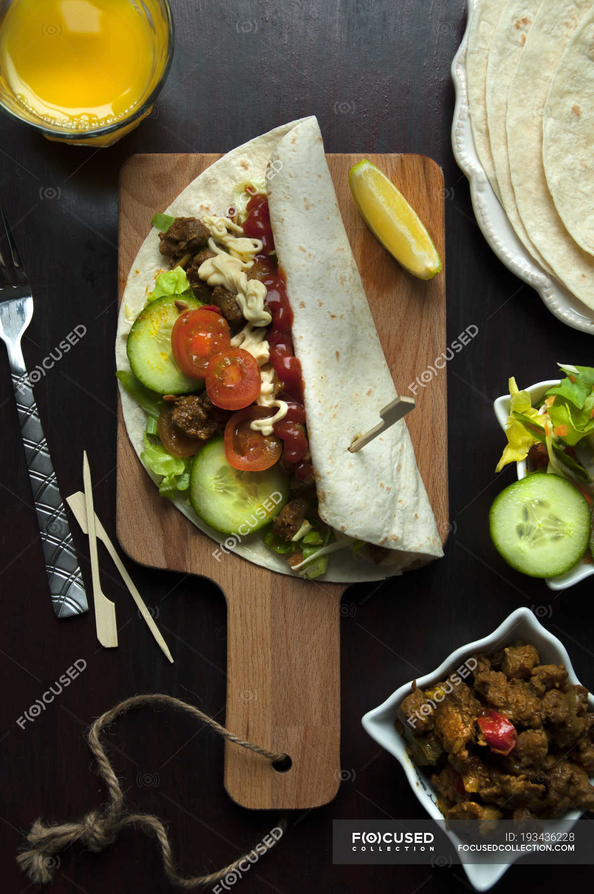 Top view of shawarma wrap over cooking board, preparation process ...