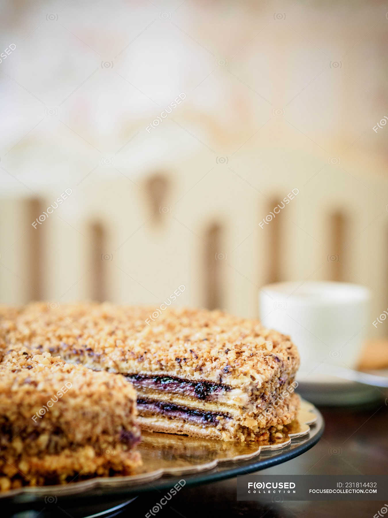 Close-up of a raspberry and nut cake with missing slice — drink, plate ...