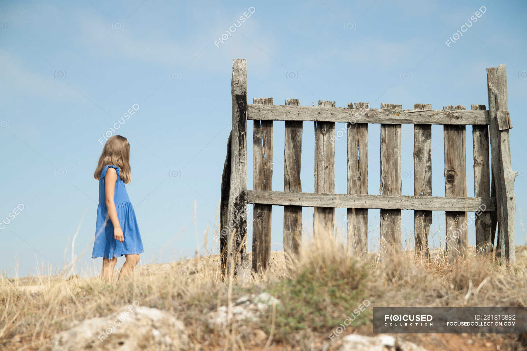 Girl walking past a fence — kid, Built Structure - Stock Photo | #231815882