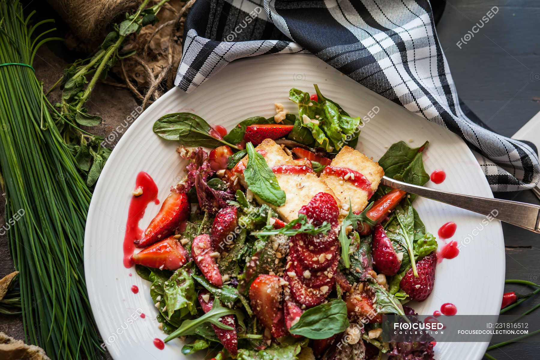 Goats Cheese, strawberry and rocket salad in white plate — close up
