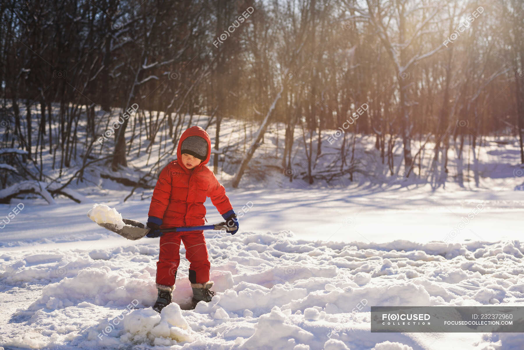 Boy shoveling snow on meadow in winter — holding, sports - Stock Photo ...