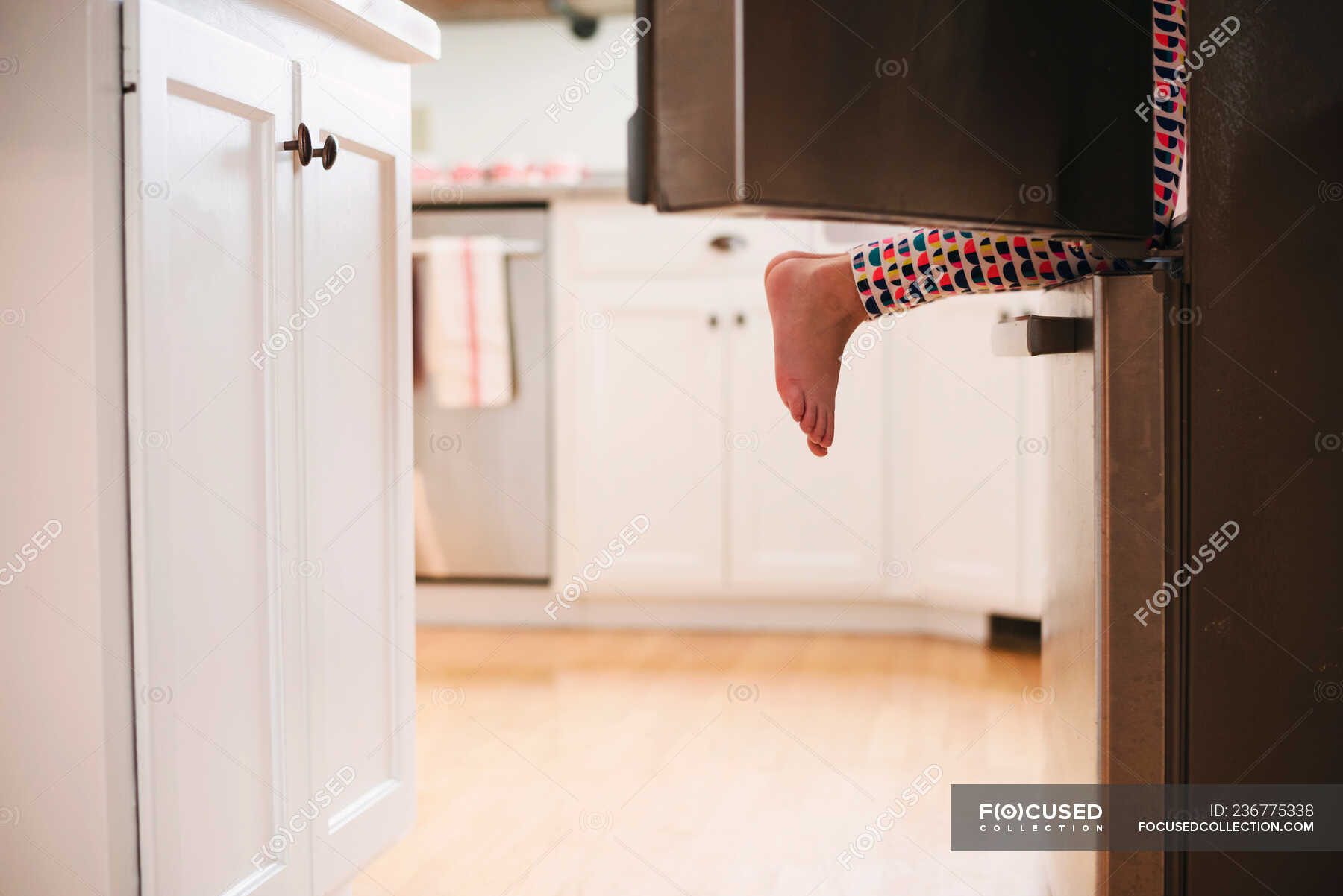 Young girl climbing into a refrigerator — snack, fridge Stock Photo