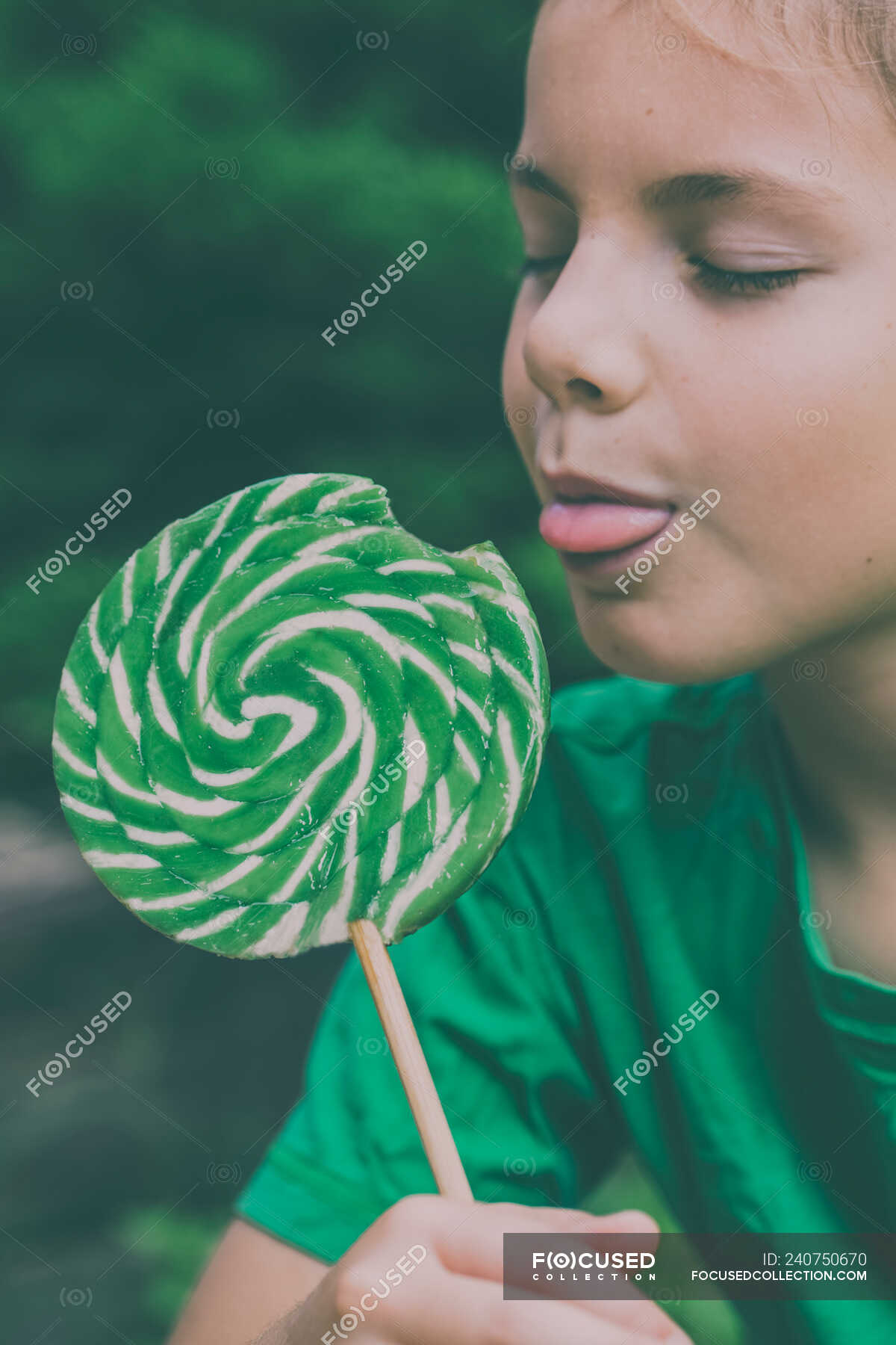 Focused 240750670 Stock Photo Adorable Boy Eating Lollipop Nature 