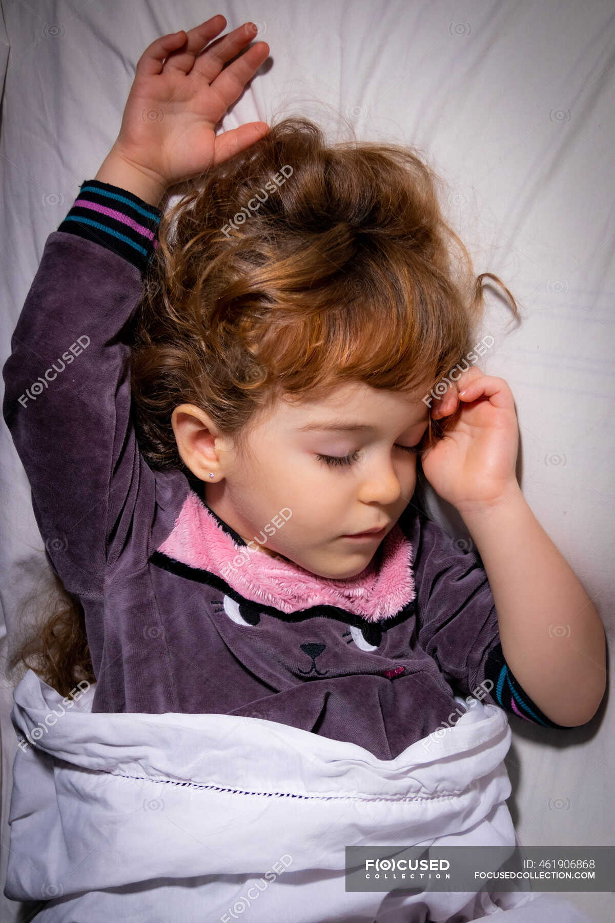 Overhead view of a girl sleeping in bed — indoors, only children