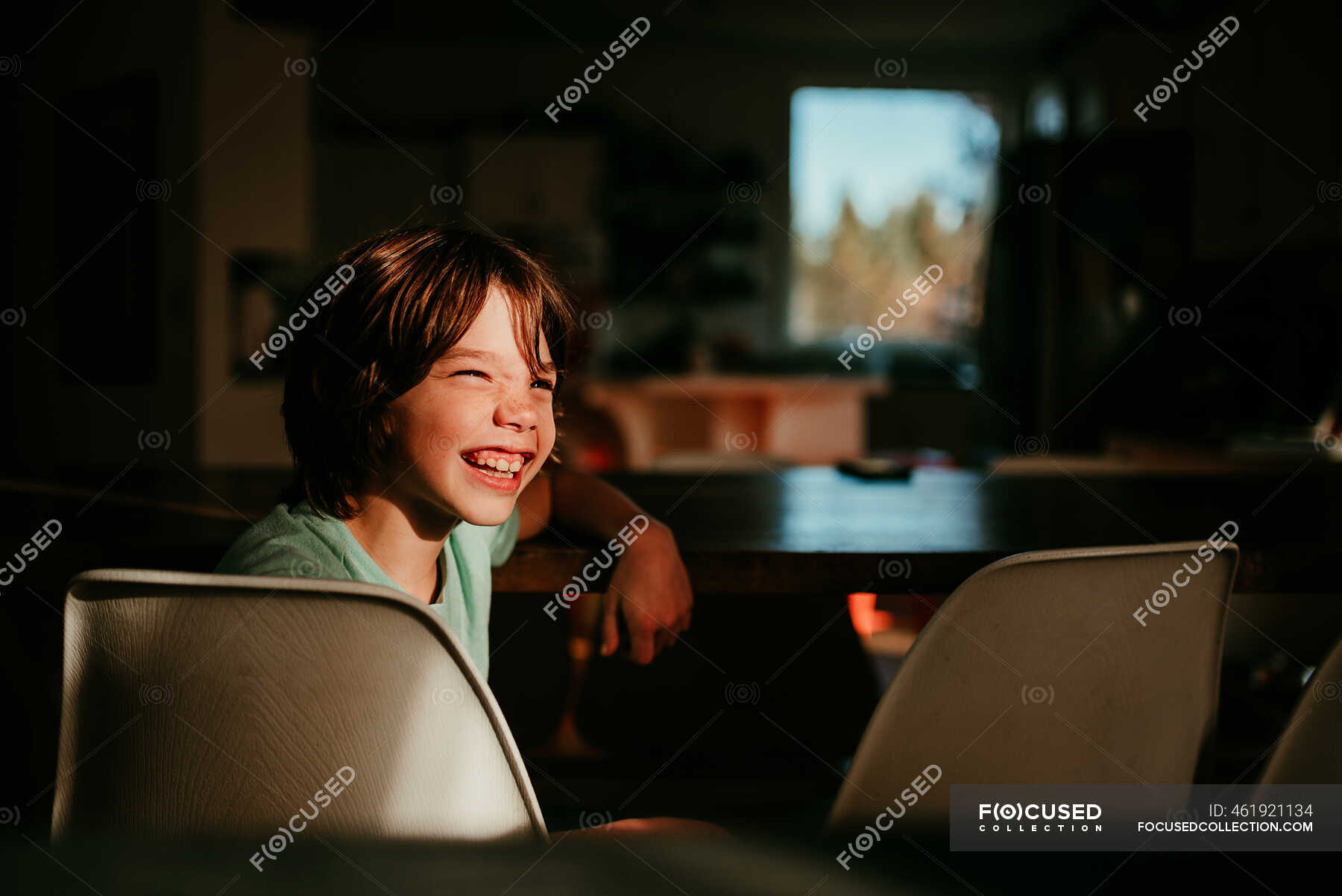 Happy boy sitting at a dining room table — Real People, active - Stock ...