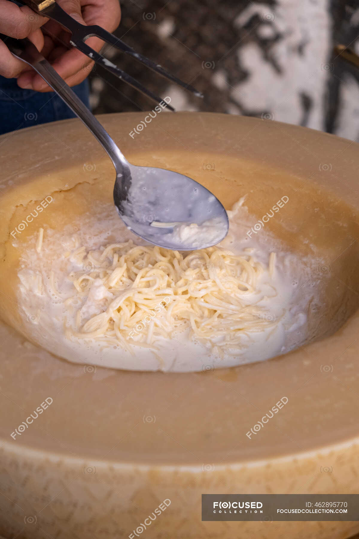 Man preparing pasta in a padano grana cheese wheel — italian food,  preparation - Stock Photo | #462895770