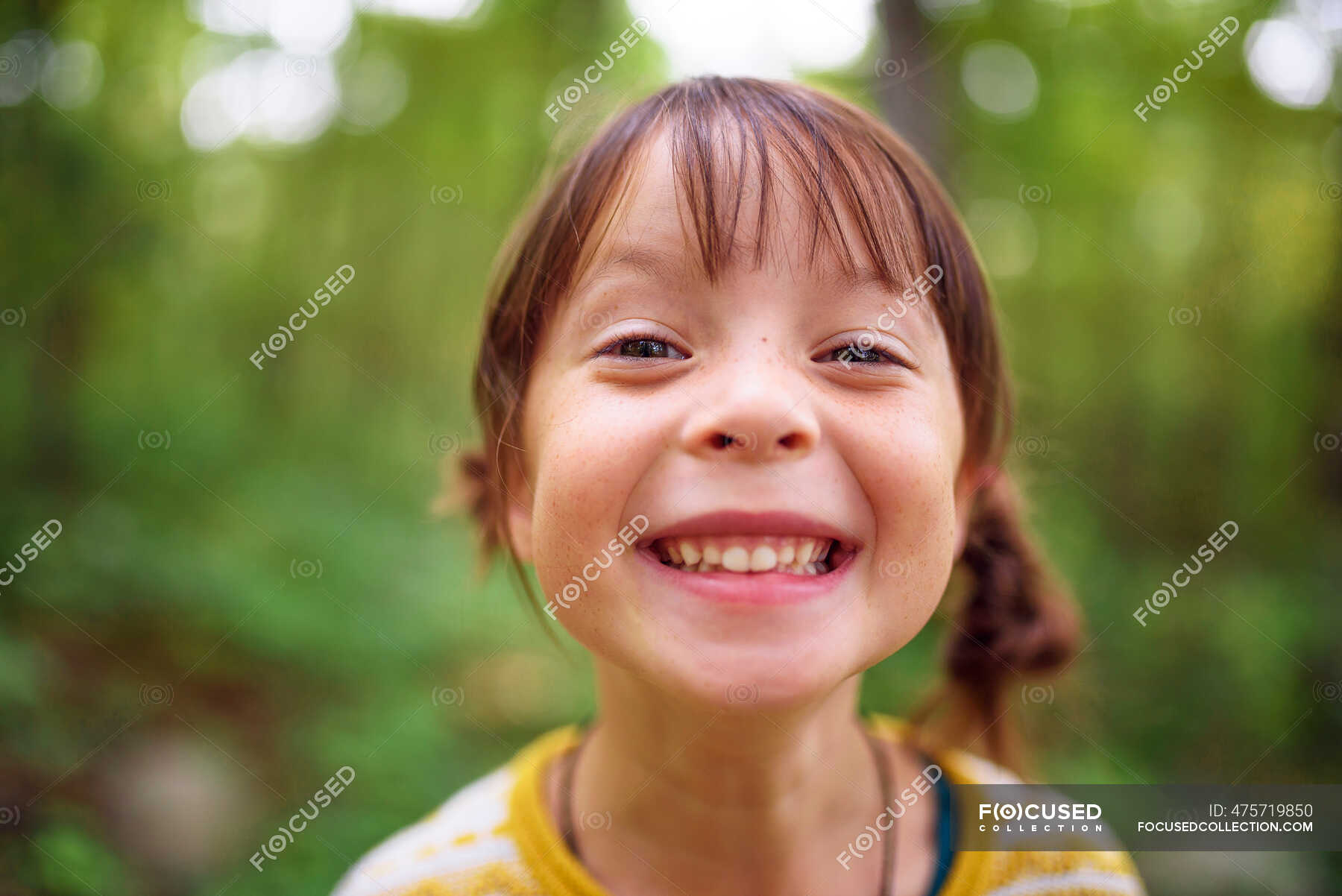 Portrait Of A Smiling Girl Standing Outdoors United States — Looking