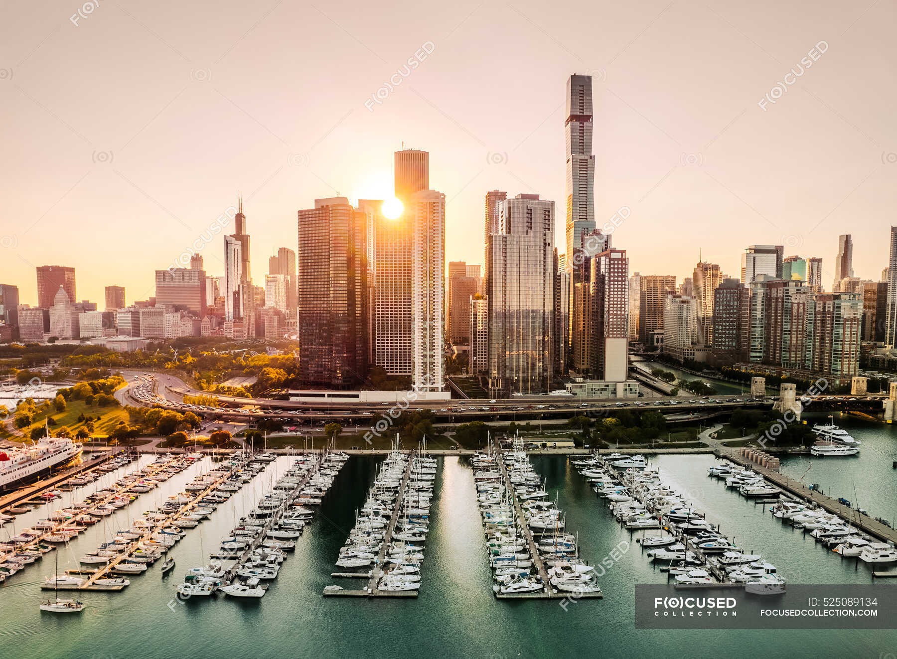 Aerial view of city skyline and boats in marina at sunset, Chicago ...