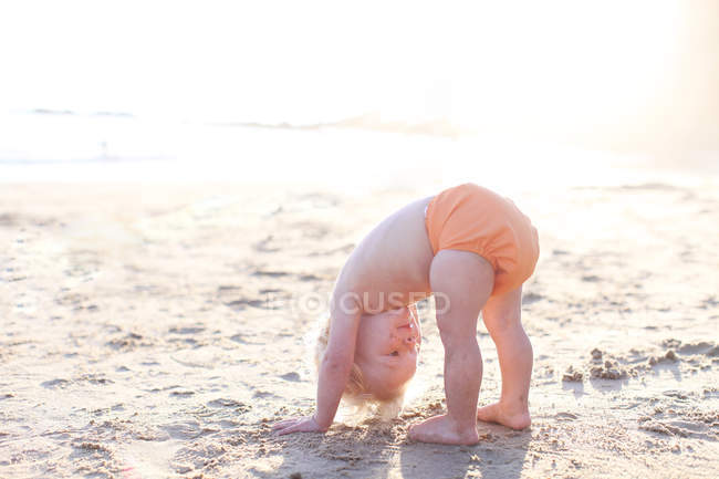 Toddler boy bending down — Stock Photo