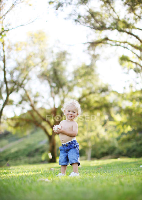Toddler holding baseball ball — Stock Photo
